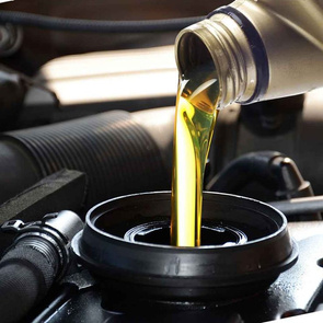 Engine oil being poured into an engine filler opening